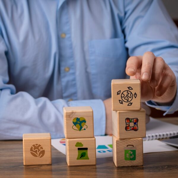 front-view-man-with-wooden-blocks_23-2150196690
